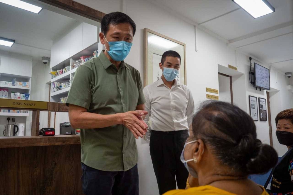 Dr Lim Hong Shen (right) from A Medical Clinic in Everton Park near Tanjong Pagar looking on as Health Minister Ong Ye Kung (left) visited the clinic. ― TODAY pic