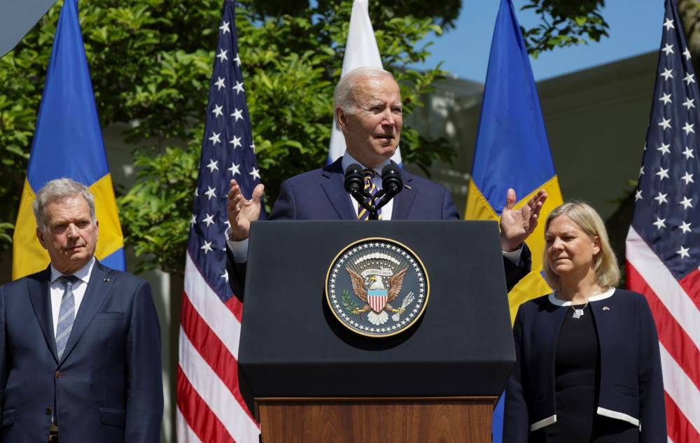 US President Joe Biden delivers remarks next to Sweden's Prime Minister Magdalena Andersson and Finland's President Sauli Niinisto, in the Rose Garden of the White House in Washington May 19, 2022. — Reuters pic
