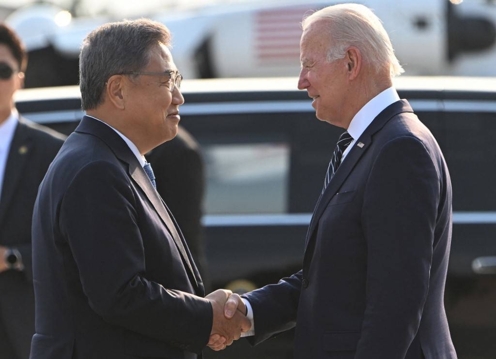 US President Joe Biden (right) shakes hands with South Korea’s Foreign Minister Park Jin upon arriving at Osan Air Base in Pyeongtaek on May 20, 2022. — AFP pic