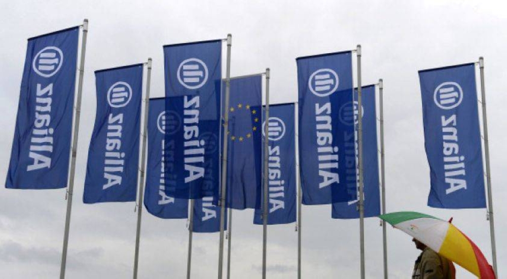 File picture shows a man walking past flags with the logo of German insurance giant Allianz prior to the companyâ€™s annual general meeting in Munich on May 7, 2014. — AFP pic