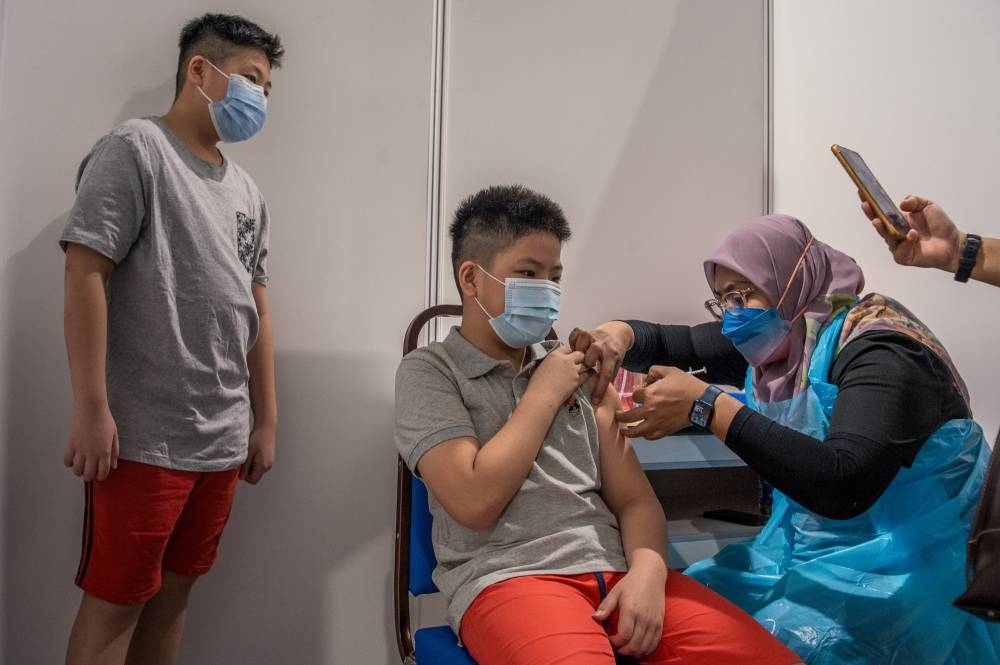 Children aged between five and 12 years old get their Covid-19 vaccine during the National Covid-19 Immunisation Programme for Kids (PICKids) at Axiata Arena in Bukit Jalil February  3, 2022. ― Picture by Shafwan Zaidon