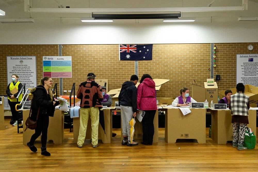 Voters line up inside a Waverley suburb polling station to cast their ballots on the day of the national election in Sydney, Australia, May 21, 2022. ― Reuters pic