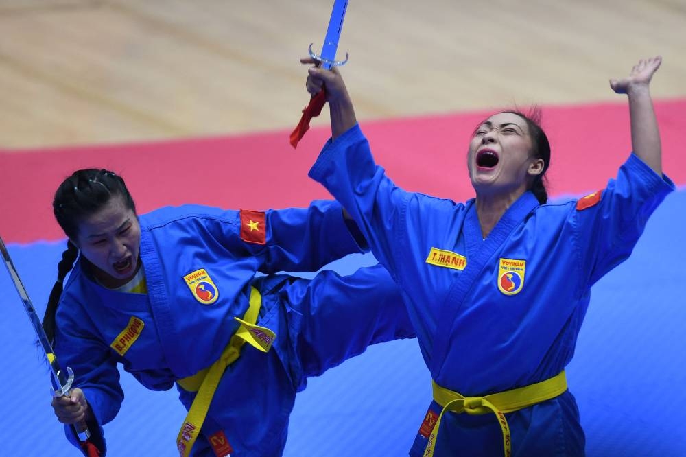 Vietnam’s Truong Thanh and Pham Thi Bich Phuong compete in the female pair sword form category of the vovinam event during the 31st Southeast Asian Games (SEA Games) in Hanoi on May 19, 2022. ― AFP pic