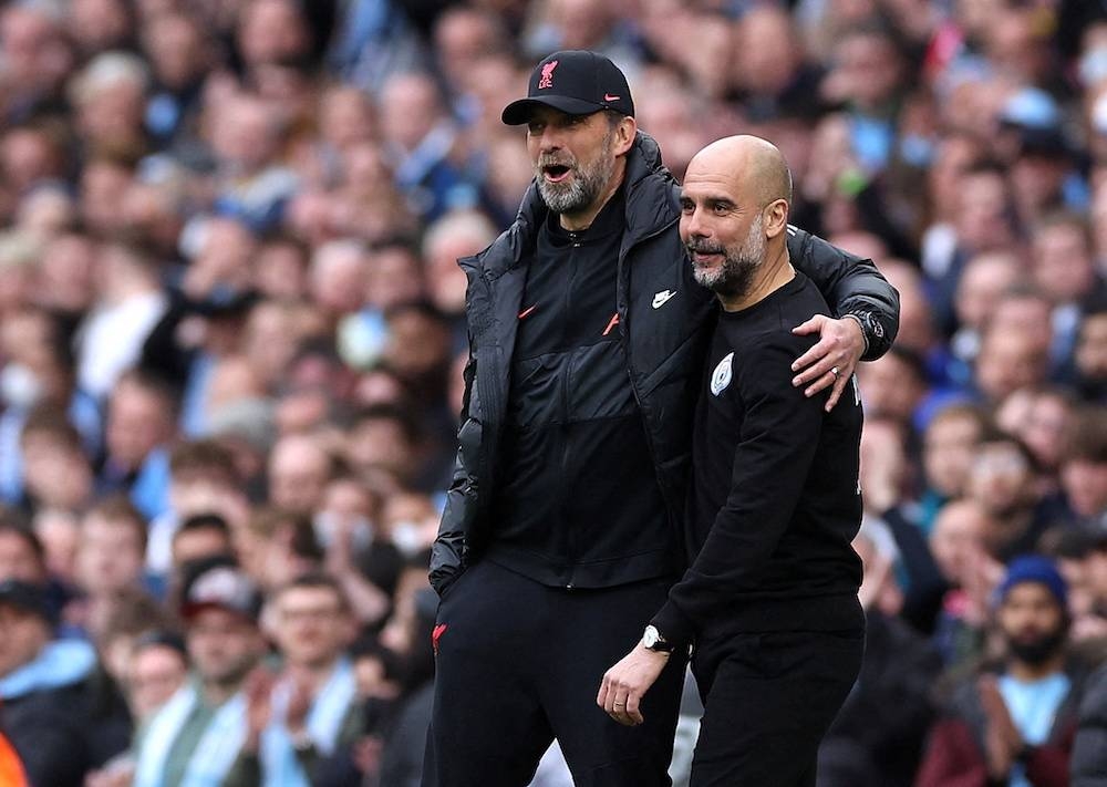 Liverpool manager Juergen Klopp and Manchester City manager Pep Guardiola at the Etihad Stadium, Manchester April 10, 2022. — Reuters pic