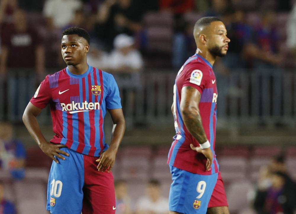 FC Barcelona's Ansu Fati and Memphis Depay look dejected after the match against Villarreal at Camp Nou, Barcelona May 22, 2022. — Reuters pic