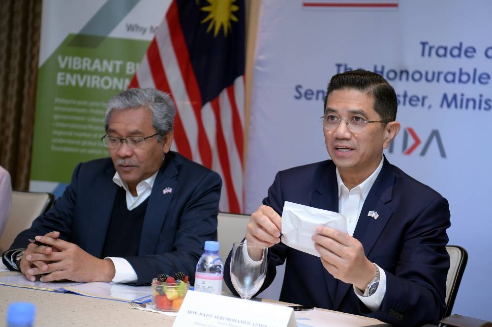 Senior Minister cum International Trade and Industry Minister Datuk Seri Mohamed Azmin Ali (right) check on a Covid test during a meeting with Cue Health in Los Angeles May 20, 2022. — Bernama pic