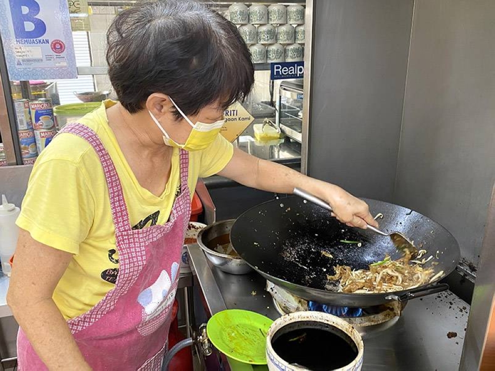 Madam Wong is now frying up the noodles rather than her husband who is suffering from poor health.