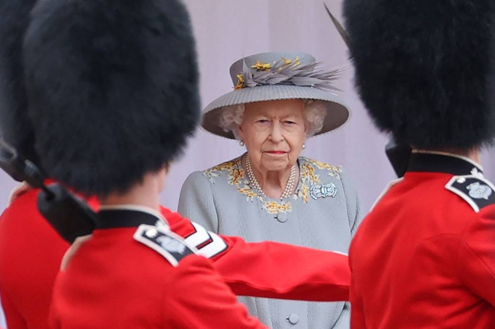 In this file photo taken on June 12, 2021 Britain's Queen Elizabeth II watches a military ceremony to mark her official birthday at Windsor Castle on June 12, 2021 in Windsor. — AFP pic