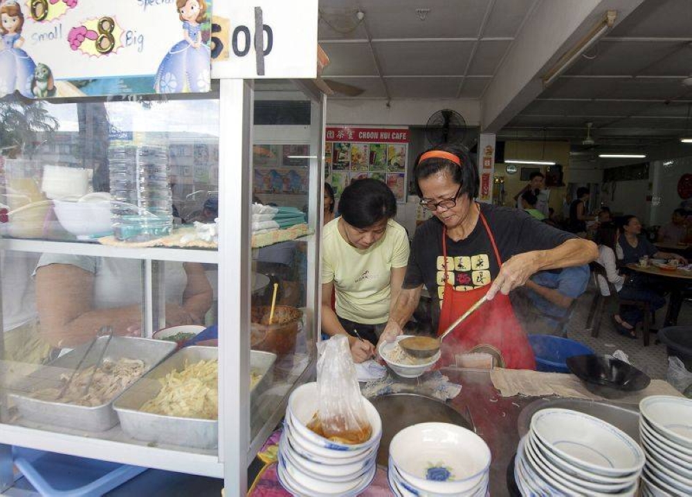A Kuching food vendor is seen preparing a bowl of Sarawak laksa in this undated file photo. Food prices in Malaysia rose over four per cent year-on-year in April 2022. — Bernama pic