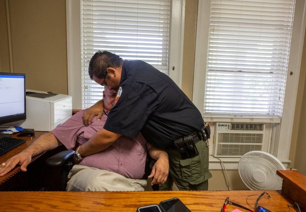 Constable David Valdez embraces Uvalde Justice of the Peace Eulalio Diaz as Diaz breaks down recounting having to identify the bodies of 19 children after they were shot by a gunman in Uvalde, Texas May 25, 2022. — Omar Ornelas/USA Today Network via Reuters