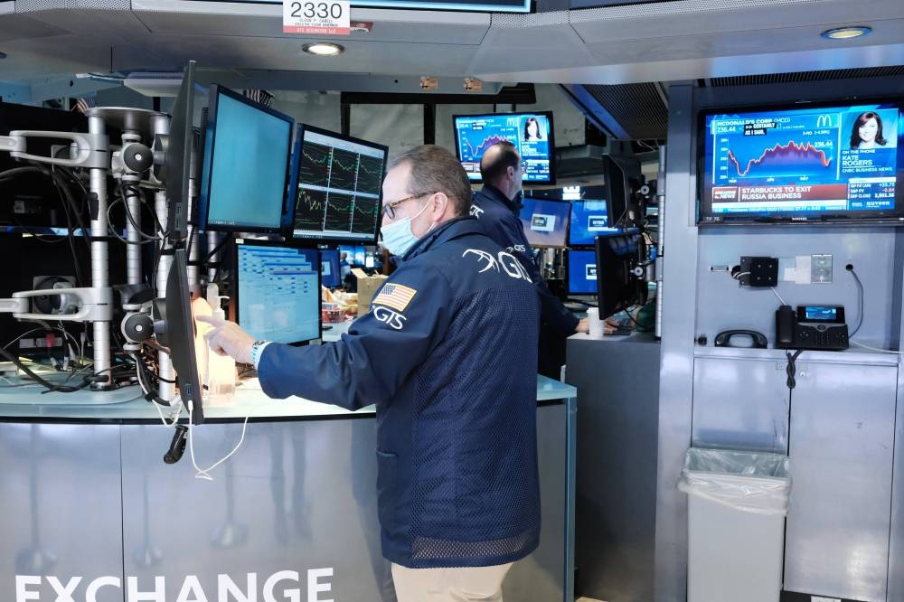 Traders work on the floor of the New York Stock Exchange (NYSE) on May 23, 2022 in New York City. — AFP pic