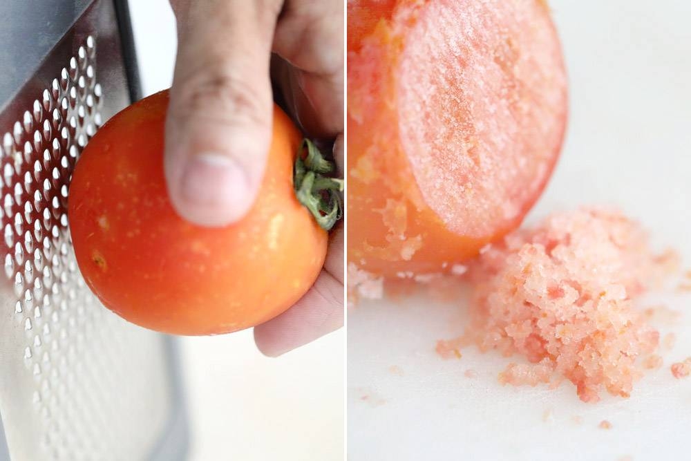 Grating the frozen tomato to get tomato 'granita.'
