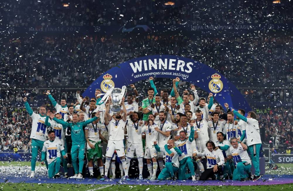 Real Madrid players celebrate with the trophy after winning the Champions League at Stade de France, Saint-Denis near Paris May 28, 2022. — Reuters pic