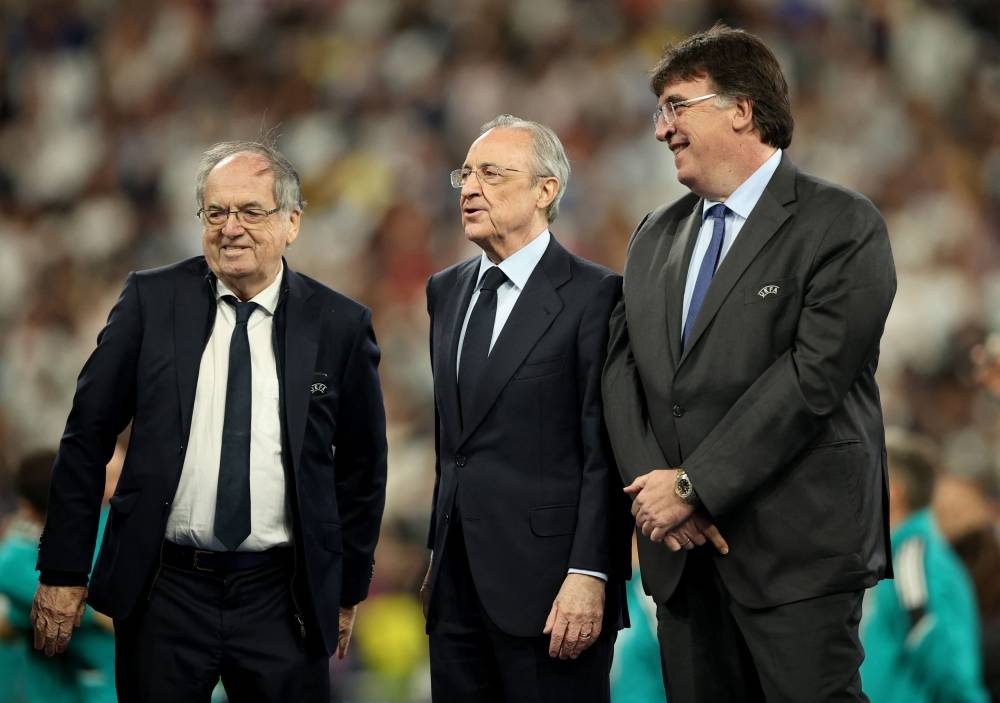 Real Madrid president Florentino Perez (centre) walks on the pitch after the match against Liverpool at Stade de France, Saint-Denis near Paris May 28, 2022. — Reuters pic