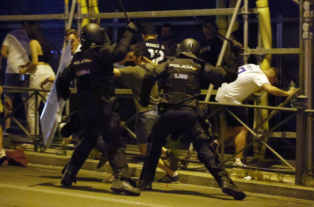 Police officers clash with fans after Real Madrid won the Champions League Final match between Liverpool and Real Madrid in Madrid May 29, 2022. — Reuters pic