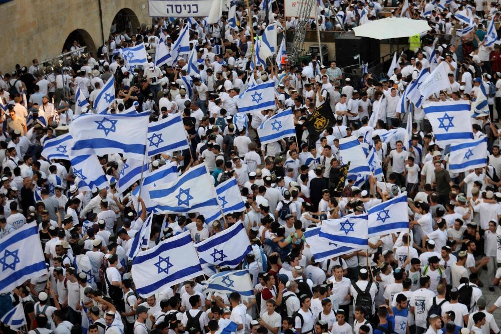 Demonstrators gather with Israeli flags near the Western Wall of the old city of Jerusalem May 29, 2022, during the Israeli 'flags march' to mark 'Jerusalem Day'. — AFP pic