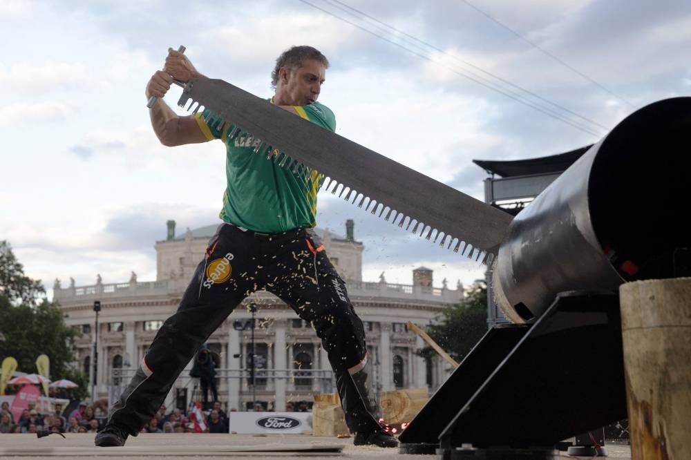Third placed Australia's Brad de Losa competes in a wood chopping competition of the Timbersports World Trophy 2022, in Vienna May 28, 2022. — AFP pic