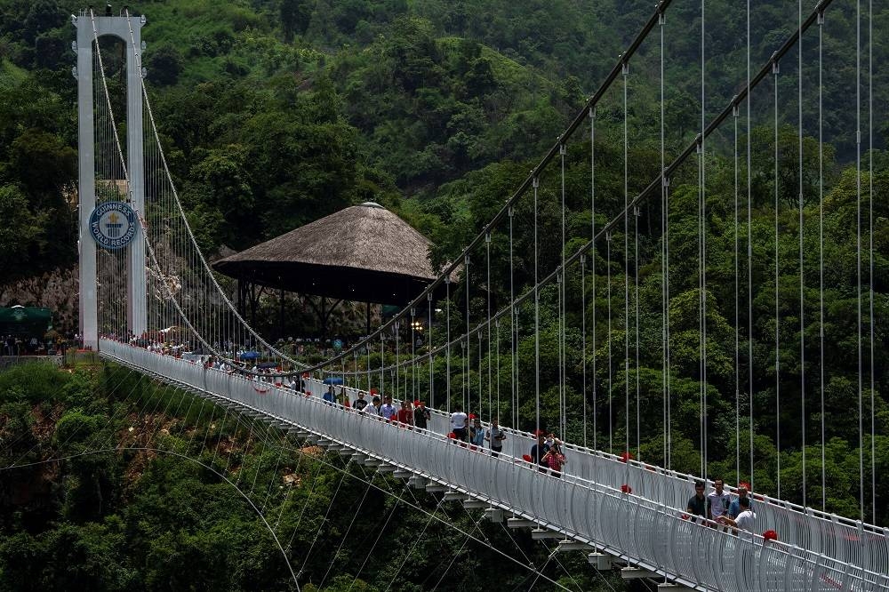 People walk on the Bach Long glass bridge during the opening ceremony at Moc Chau district in Son La province, Vietnam, May 28, 2022.  — Reuters pic
