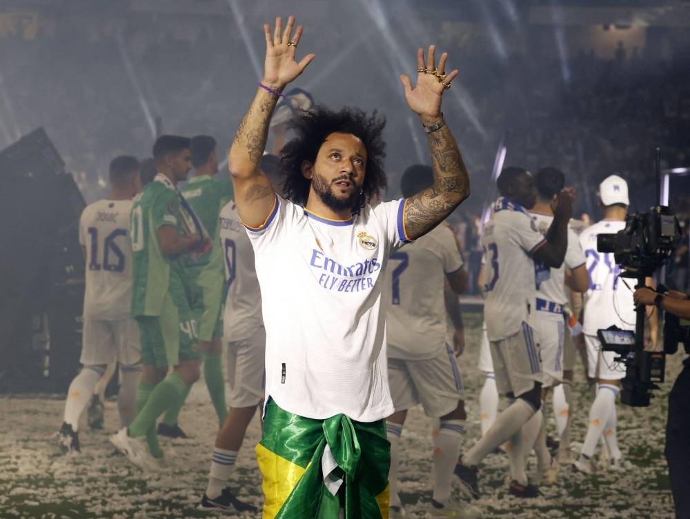 Real Madrid's Marcelo with teammates celebrate after winning the Champions League final at the Santiago Bernabeu in Madrid May 29, 2022. — Reuters pic  