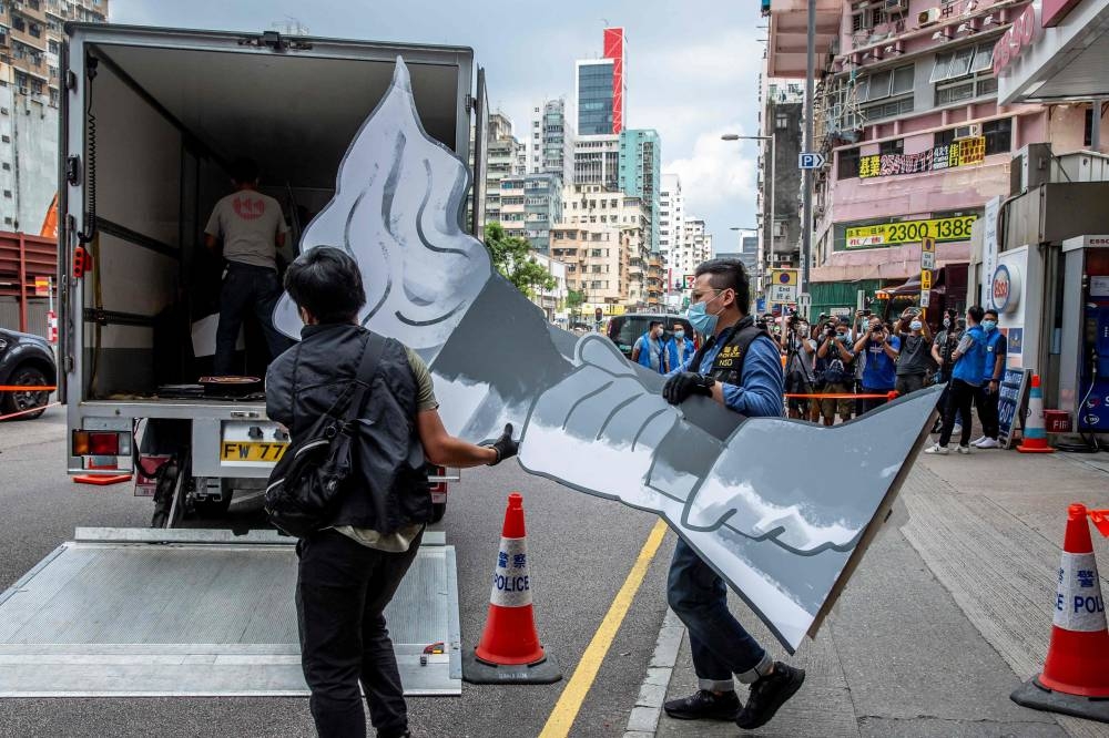 This file photo shows police officers from the National Security Department taking away items after raiding the June 4 museum dedicated to the 1989 Tiananmen Square crackdown, in Hong Kong September 9, 2021. — AFP pic