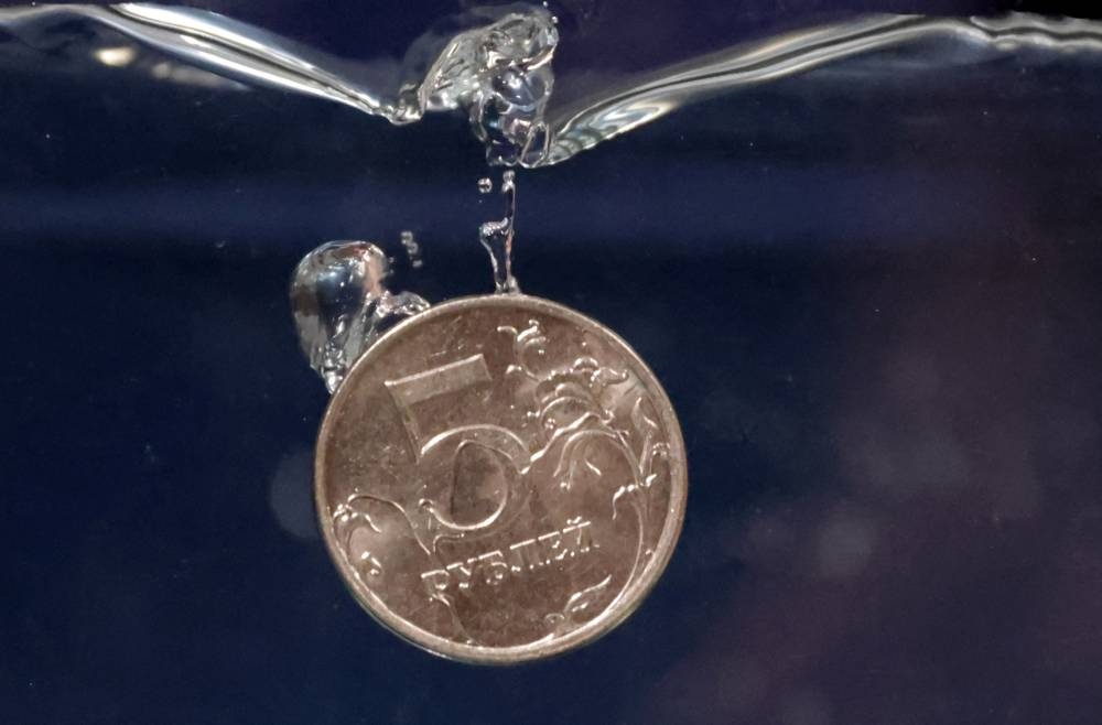 A Rouble coin plunges into water in this illustration taken, May 23, 2022. — Reuters pic