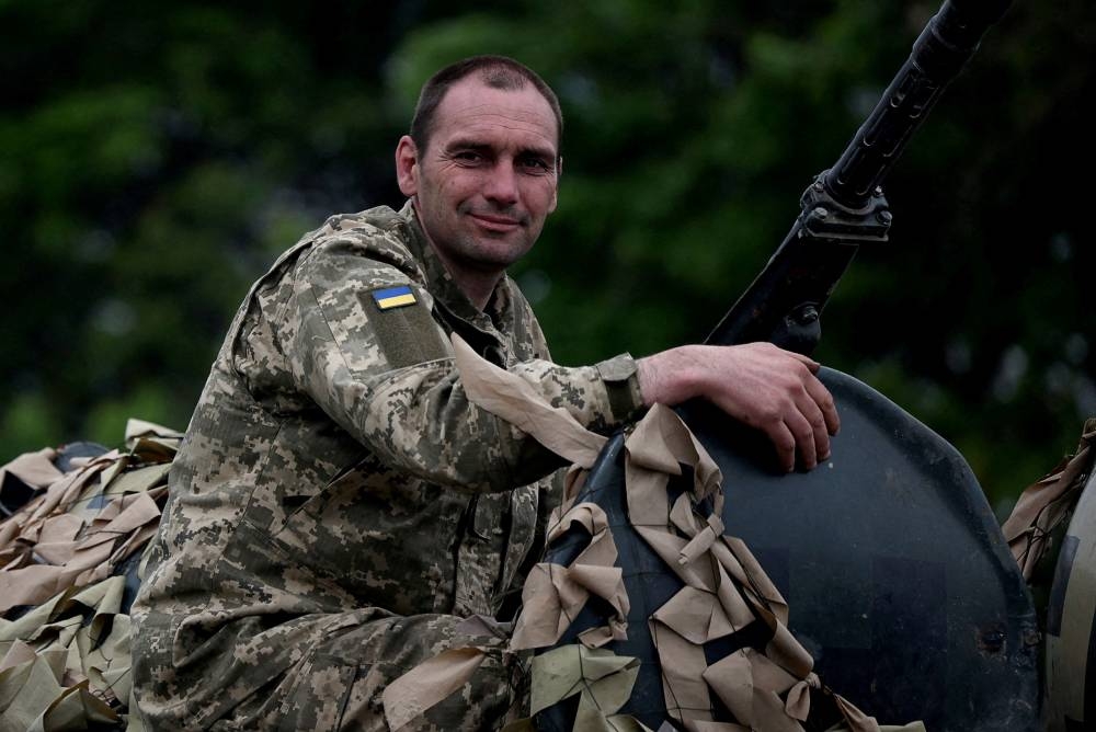 A Ukrainian service member rides on top of a military vehicle, amid Russia's invasion of Ukraine, on the road between Kramatorsk and Sloviansk, Donetsk region, Ukraine, May 28, 2022. — Reuters pic