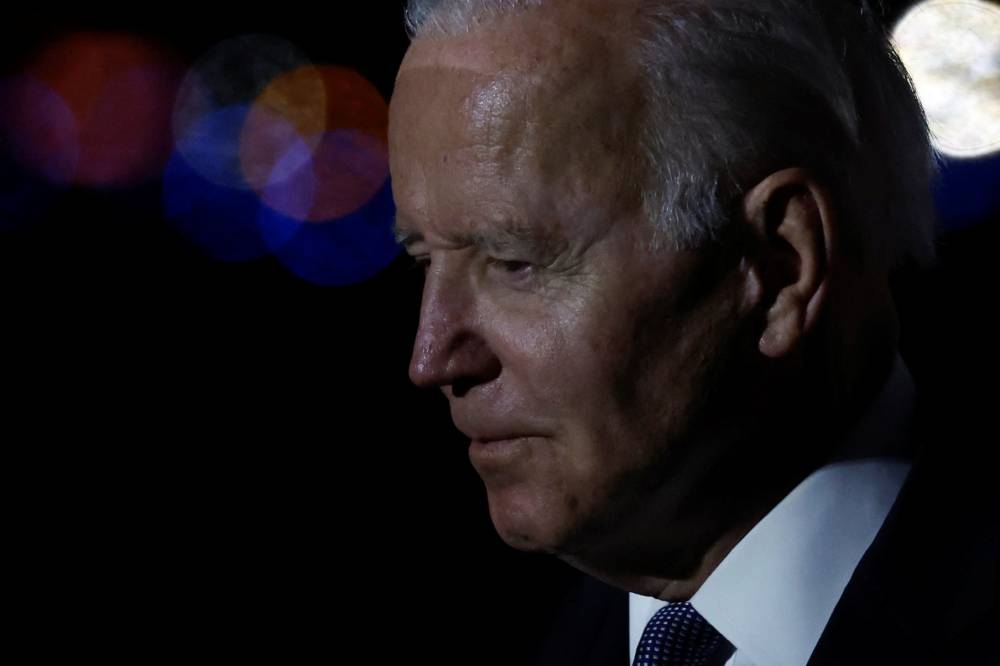 US President Joe Biden stands on the tarmac after arriving home aboard Air Force One after a day in Uvalde, Texas, at Delaware Air National Guard Base in New Castle, Delaware, May 29, 2022. — Reuters pic 