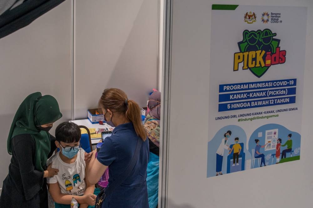 Children aged between five and 12 get their Covid-19 vaccine at the Axiata Arena in Bukit Jalil February  3, 2022. — Picture by Shafwan Zaidon