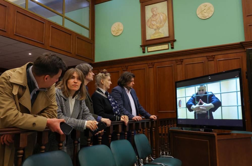 Russian opposition leader Alexei Navalny is seen on a screen via a video link from the IK-2 corrective penal colony in Pokrov during a court hearing to consider an appeal against his prison sentence in Moscow, Russia May 24, 2022. — Reuters pic