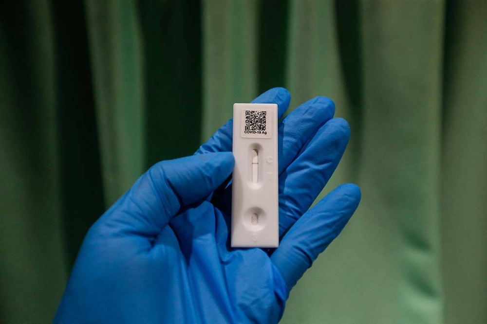 A health personnel holds up a Covid-19 test strip indicating a negative result in Seberang Jaya April 7, 2022. — Picture by Sayuti Zainudin