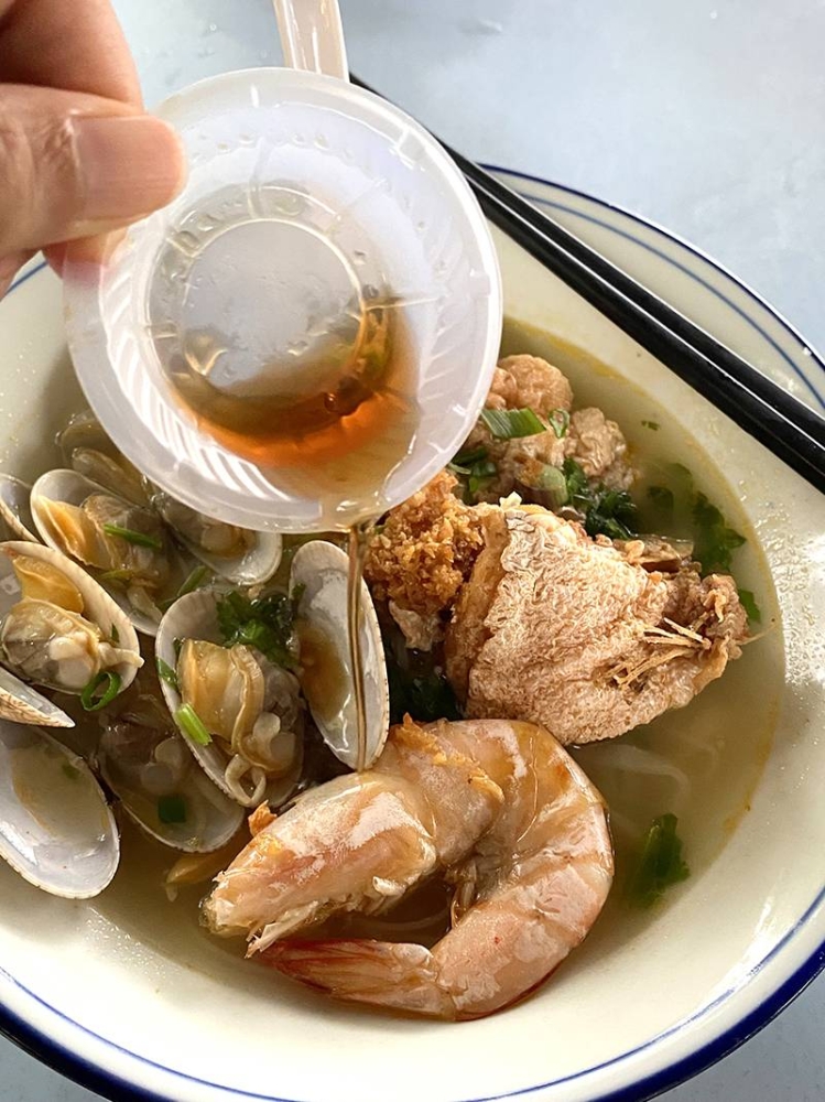 At Pangkor Seafood Noodle, you can add wine that they give you at the side to enhance the taste of the soup