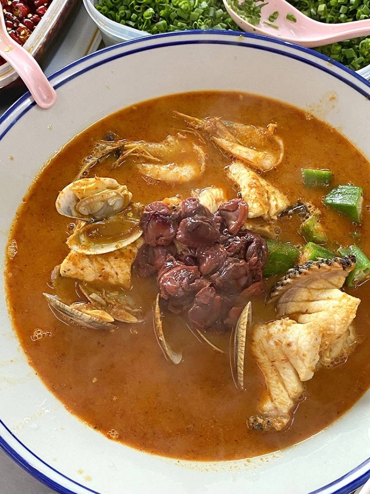 Go for the ultimate seafood bowl with fish, clams and fresh cockles at Pangkor Seafood Hainan Curry