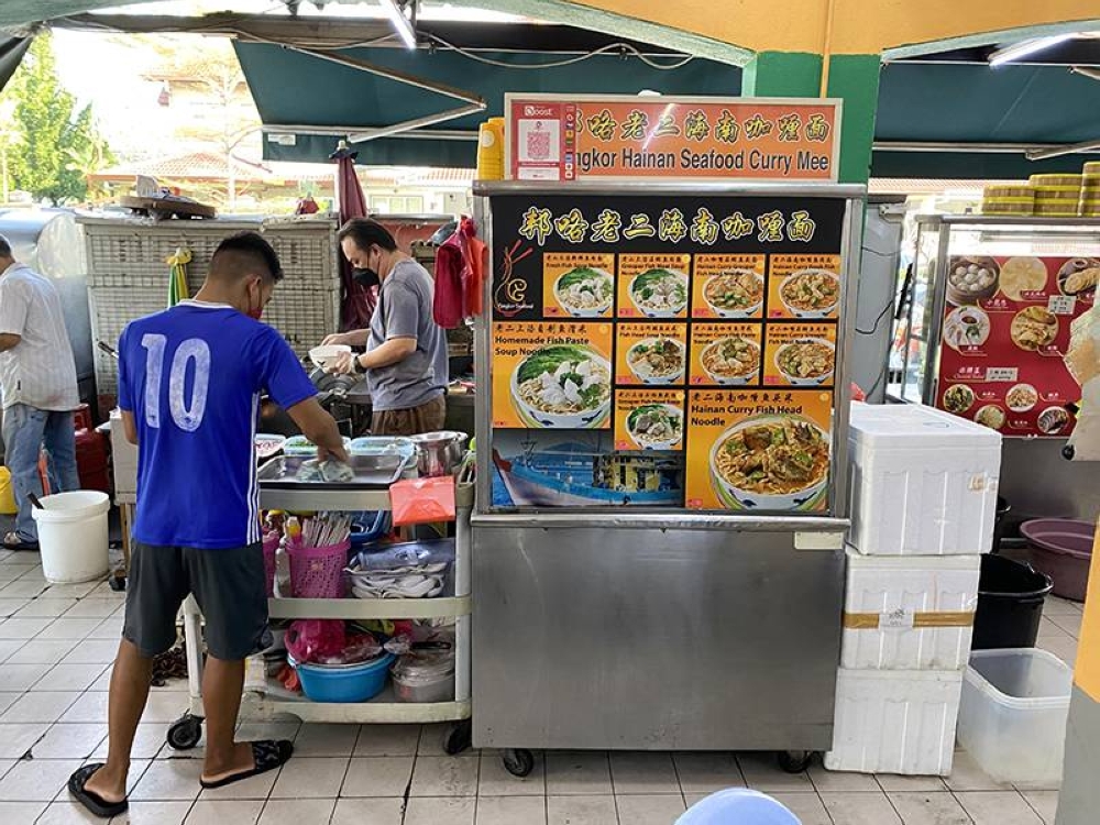 Look for the Pangkor Hainan Seafood Curry Mee stall where everything is cooked to order