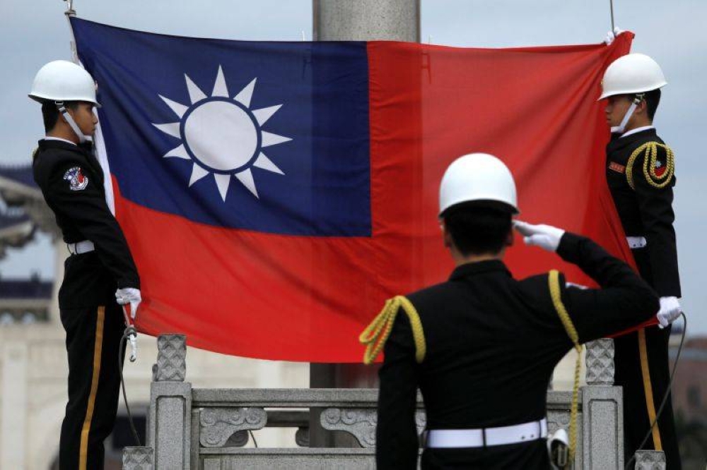 Military honour guards attend a flag-raising ceremony at Chiang Kai-shek Memorial Hall, in Taipei March 16, 2018. — Reuters pic