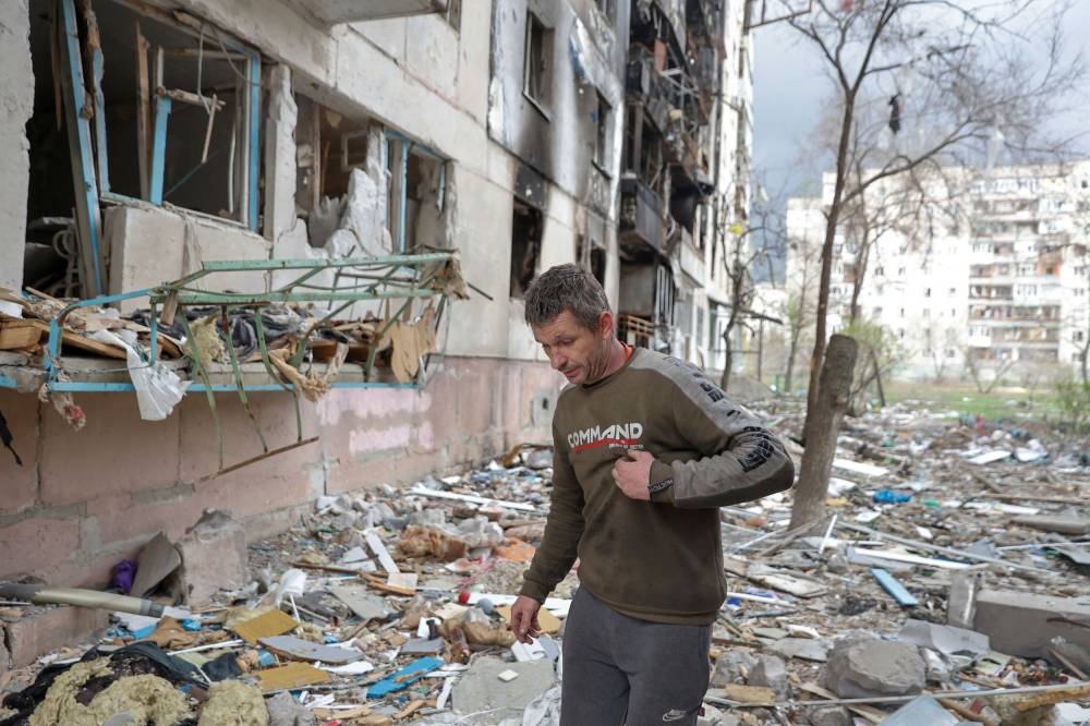 Local resident Viacheslav walks on debris of a residential building damaged by a military strike, as Russia's attack on Ukraine continues, in Sievierodonetsk, Luhansk region, Ukraine April 16, 2022. — Reuters pic