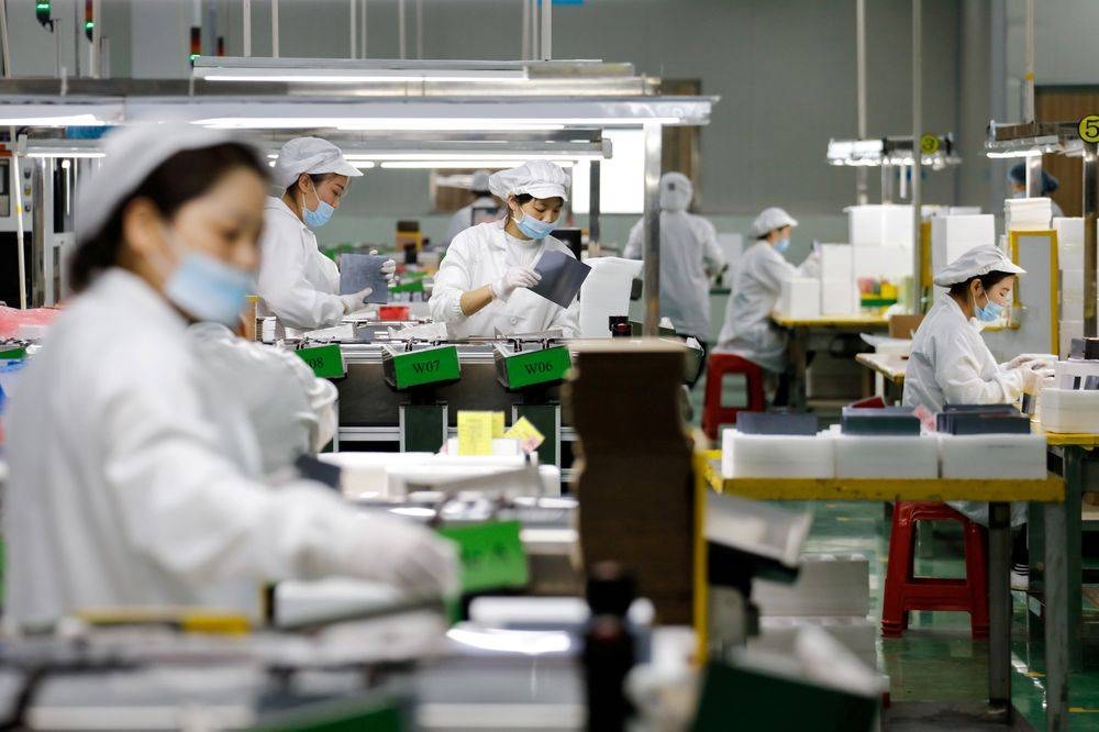 Employees work at an assembly line of a company producing solar panel components in Jiujiang, Jiangxi province March 16, 2018. — Reuters pic