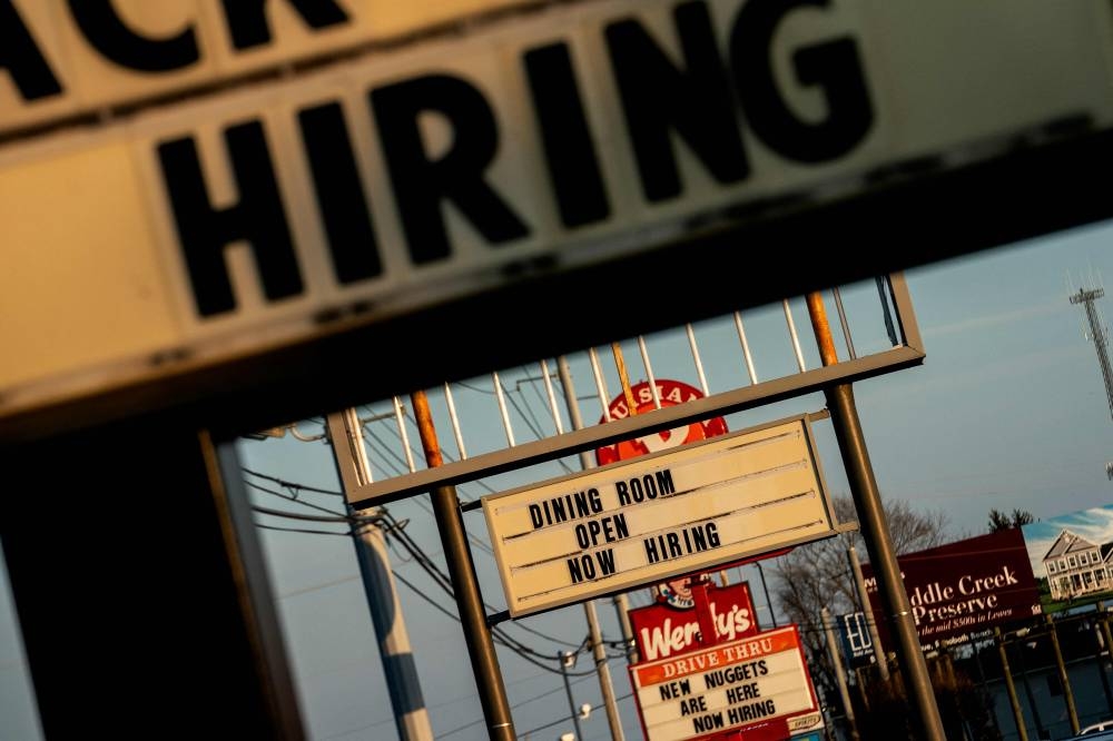 In this file photo taken on March 19, 2022 “Now Hiring” signs are displayed in front of restaurants in Rehoboth Beach, Delaware. — AFP pic