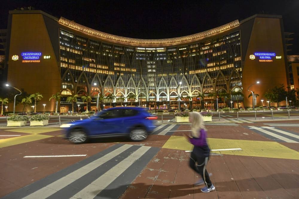 File picture of budget staff working overtime at the Ministry of Finance Complex ahead of the 2022 Budget presentation on Friday, October 27, 2021. — Bernama pic