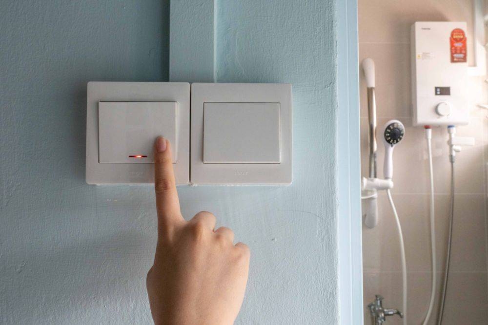 A double pole switch outside a bathroom being pressed for a water heater that is typically installed in public flats. Such switches should be used, electricians said, instead of a power socket for a standard three-pin plug often seen in other home appliances. — TODAY pic