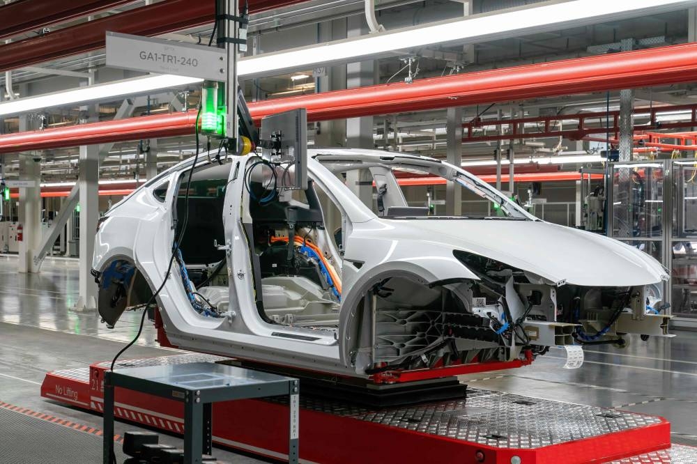 Cars are seen on the assembly line during a tour of the Tesla Giga Texas manufacturing facility ahead of the 'Cyber Rodeo