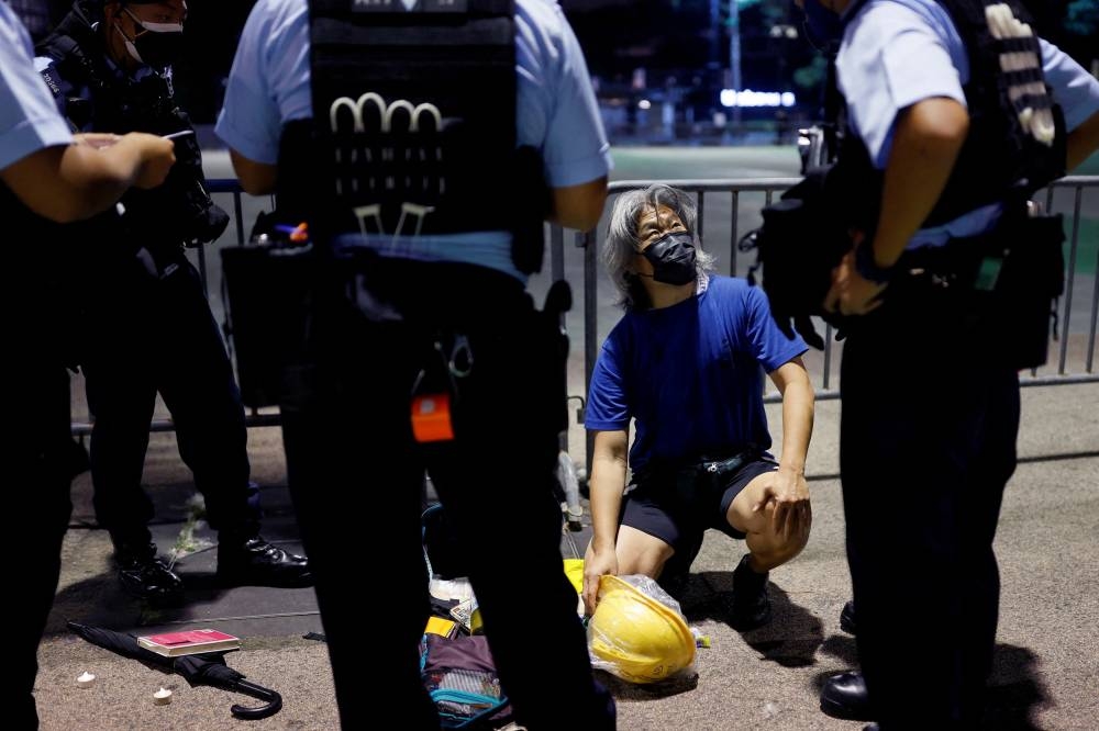 Police officers search a man at Victoria Park, where the candlelight vigil used to be held, a day a head of the 33rd anniversary of the crackdown on pro-democracy demonstrations at Beijing's Tiananmen Square, in Hong Kong June 3, 2022. — Reuters pic 