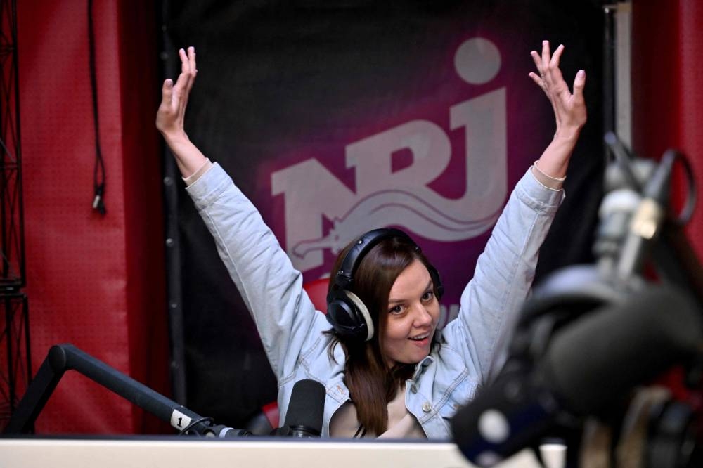 File photo of DJ Yana Manuilova gesturing during a broadcast at NRJ radio in Kyiv on April 30, 2022. ― AFP pic