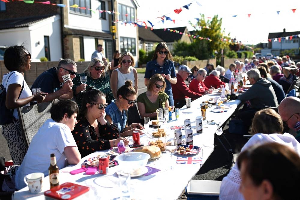 Residents of Ripon, northern England, play bingo as they gather for a dinner organised in a street of the town as part of the Queen Elizabeth II's platinum jubilee celebrations, on June 3, 2022. — AFP pic