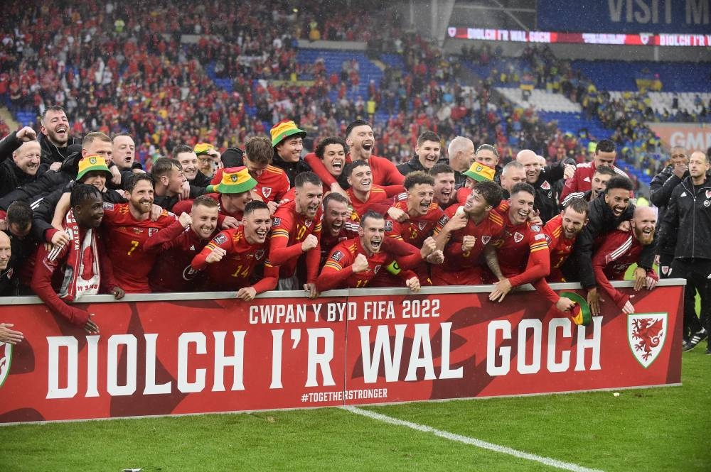 Wales players celebrate qualifying for the World Cup after beating Ukraine at the Cardiff City Stadium, Cardiff June 5, 2022. — Reuters pic