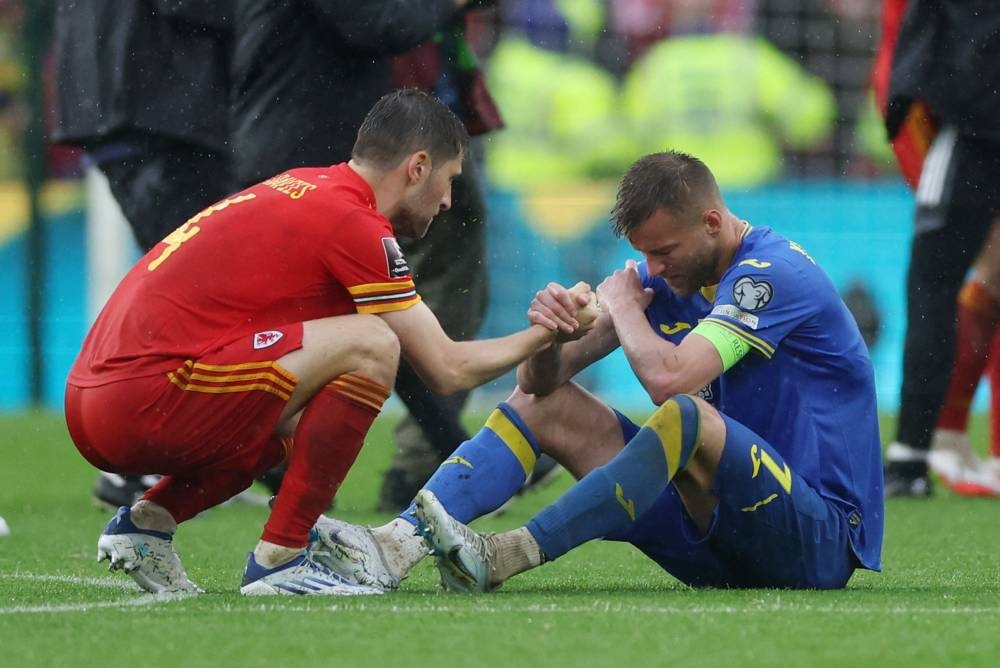 Wales' Ben Davies consoles Ukraine's Andriy Yarmolenko after their match at the Cardiff City Stadium, Cardiff June 5, 2022. — Reuters pic