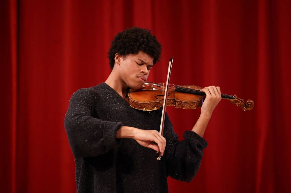 Violinist Braimah Kanneh-Mason plays the rare ‘Hellier’ violin, created by Italian luthier Antonio Stradivari in 1679, which will be offered in the Exceptional Sale at Christie’s auction house in London May 30, 2022. — Reuters pic
