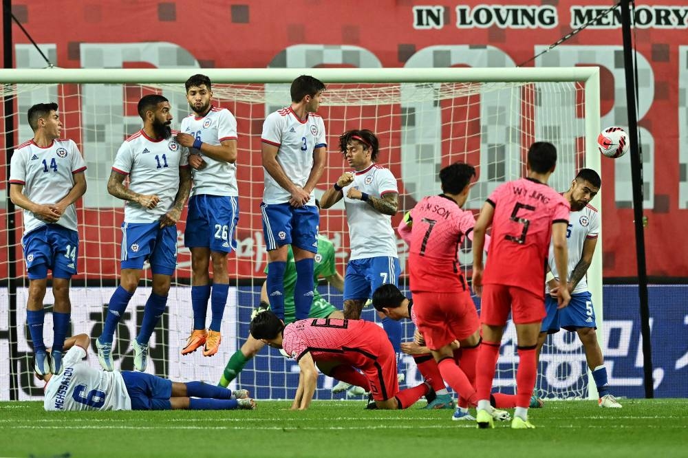 South Korea’s Son Heung-min (3rd right, Red) shoots a free kick to score against Chile during a friendly match between South Korea and Chile in Daejeon, June 6, 2022. — AFP pic 