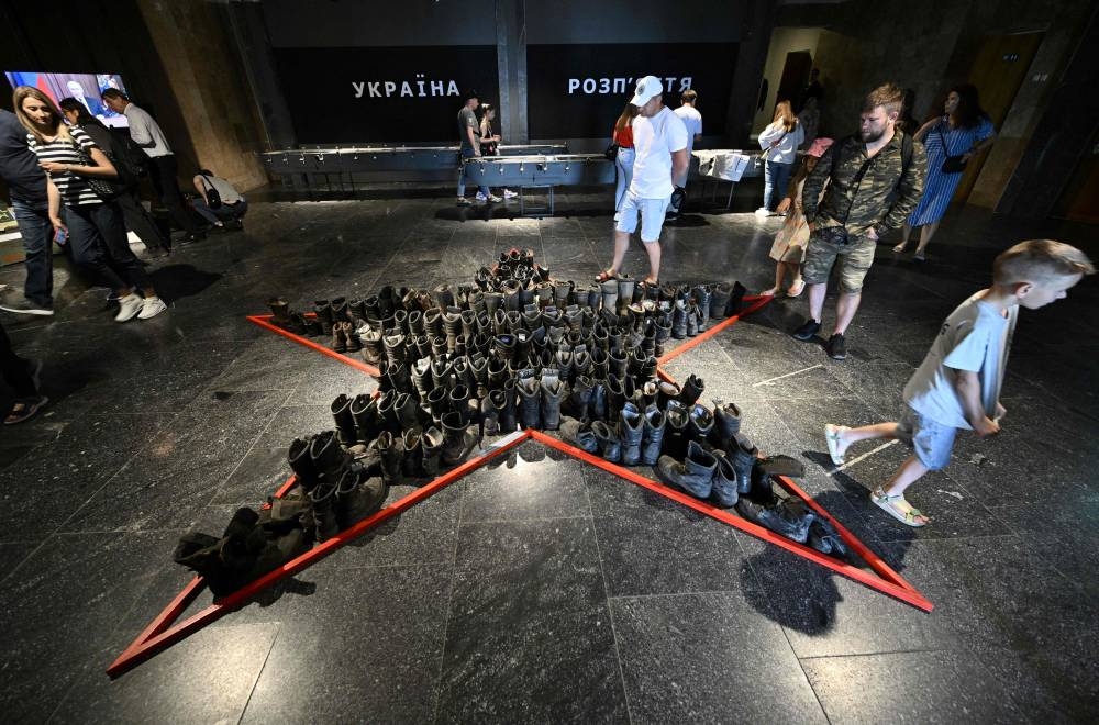 People visit the exhibition on the ongoing war ‘Ukraine – Crucifixion’ in the National Museum of the History of Ukraine in the Second World War, in Kyiv on June 4, 2022. Ukrainians flock to the capital to observe helmets, food rations and missiles left behind by the Russian army following its military redeployment and displayed in an exhibition created in real time. — AFP pic