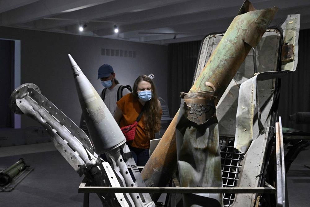 People visit the exhibition on the ongoing war ‘Ukraine – Crucifixion’ in the National Museum of the History of Ukraine in the Second World War, in Kyiv on June 4, 2022. — AFP pic