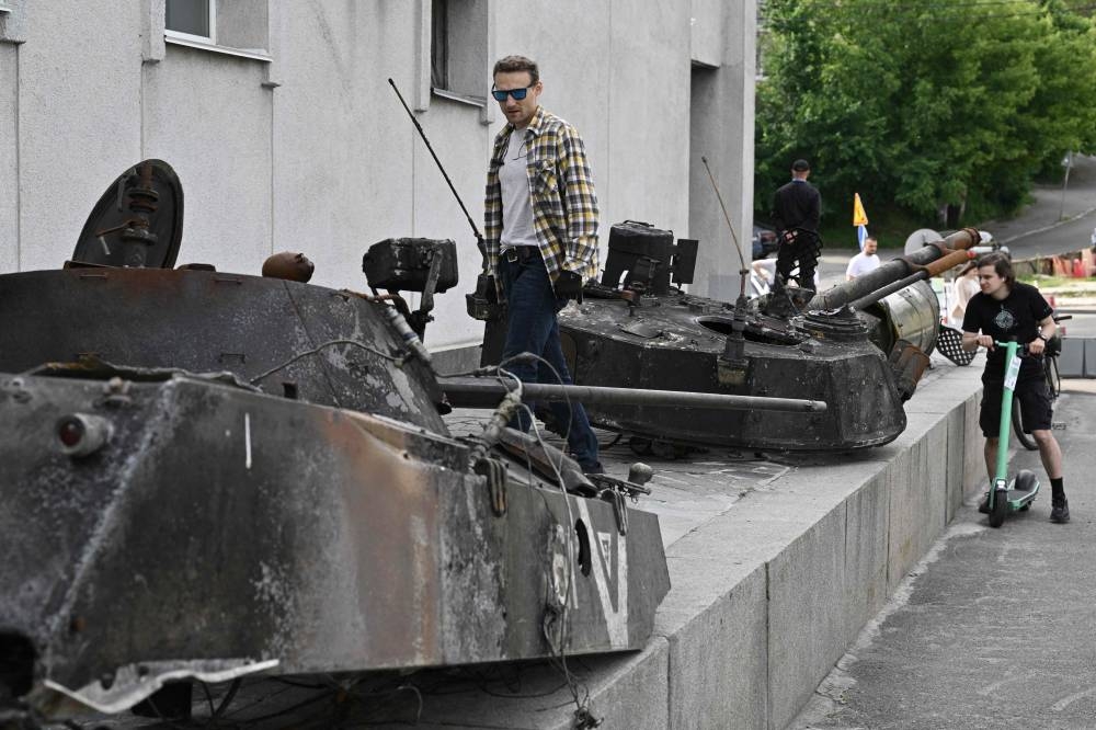 People look at the remains of Russian armoured vehicles during the exhibition on the ongoing war ‘Ukraine – Crucifixion’ at the National Museum of the History of Ukraine in the Second World War, in Kyiv, on June 4, 2022. — AFP pic